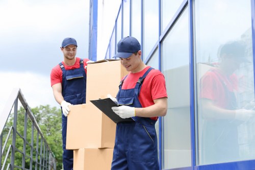 Team member preparing a safe van loading area with moving equipment
