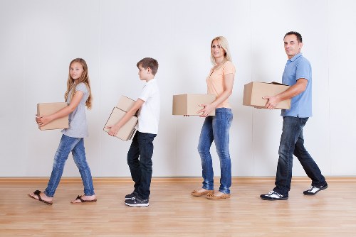 Unloading boxes and furniture into a Camden property after transport