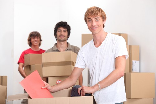 Removal team collecting old household furniture in Camden
